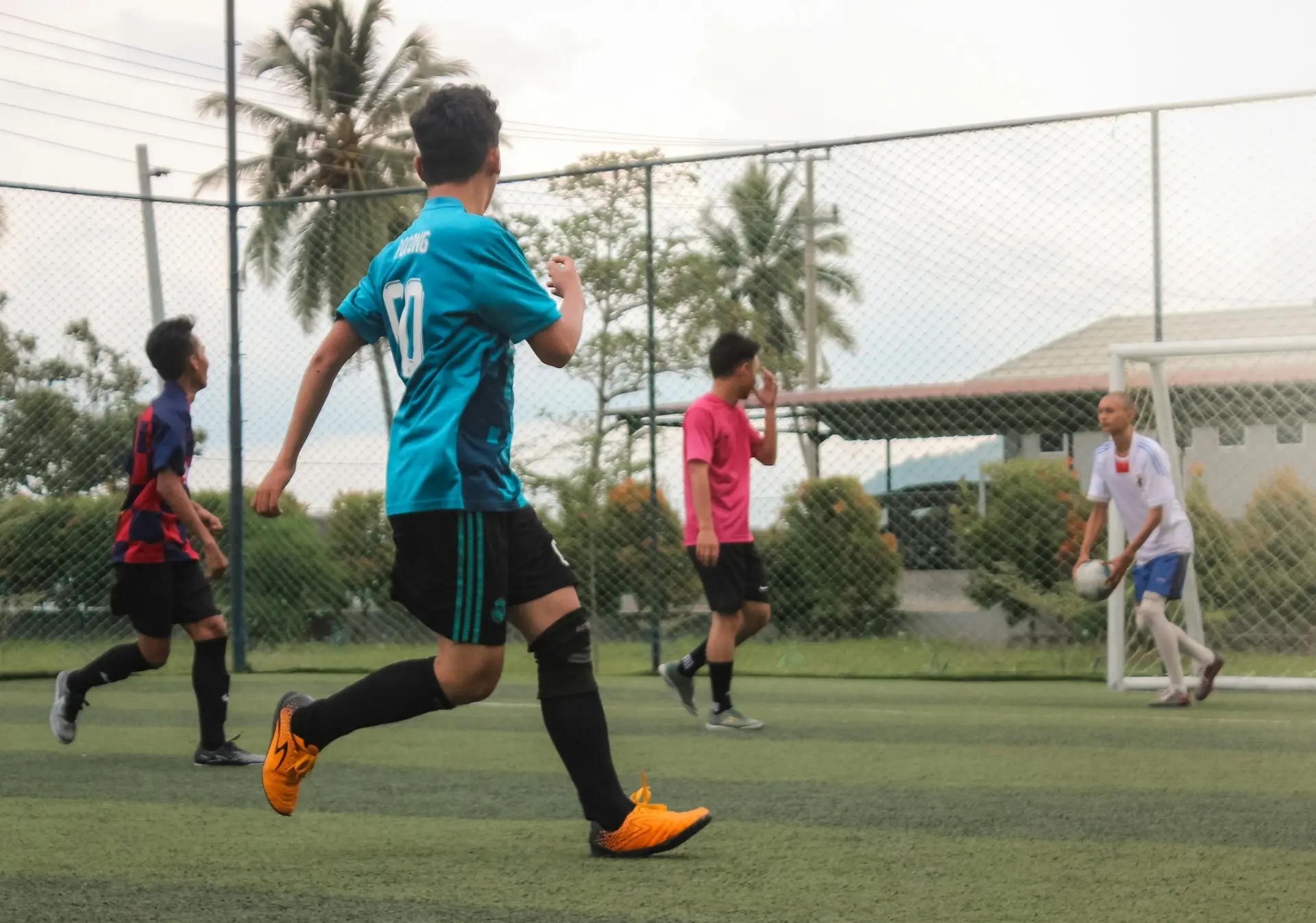 2 boys playing soccer during daytime